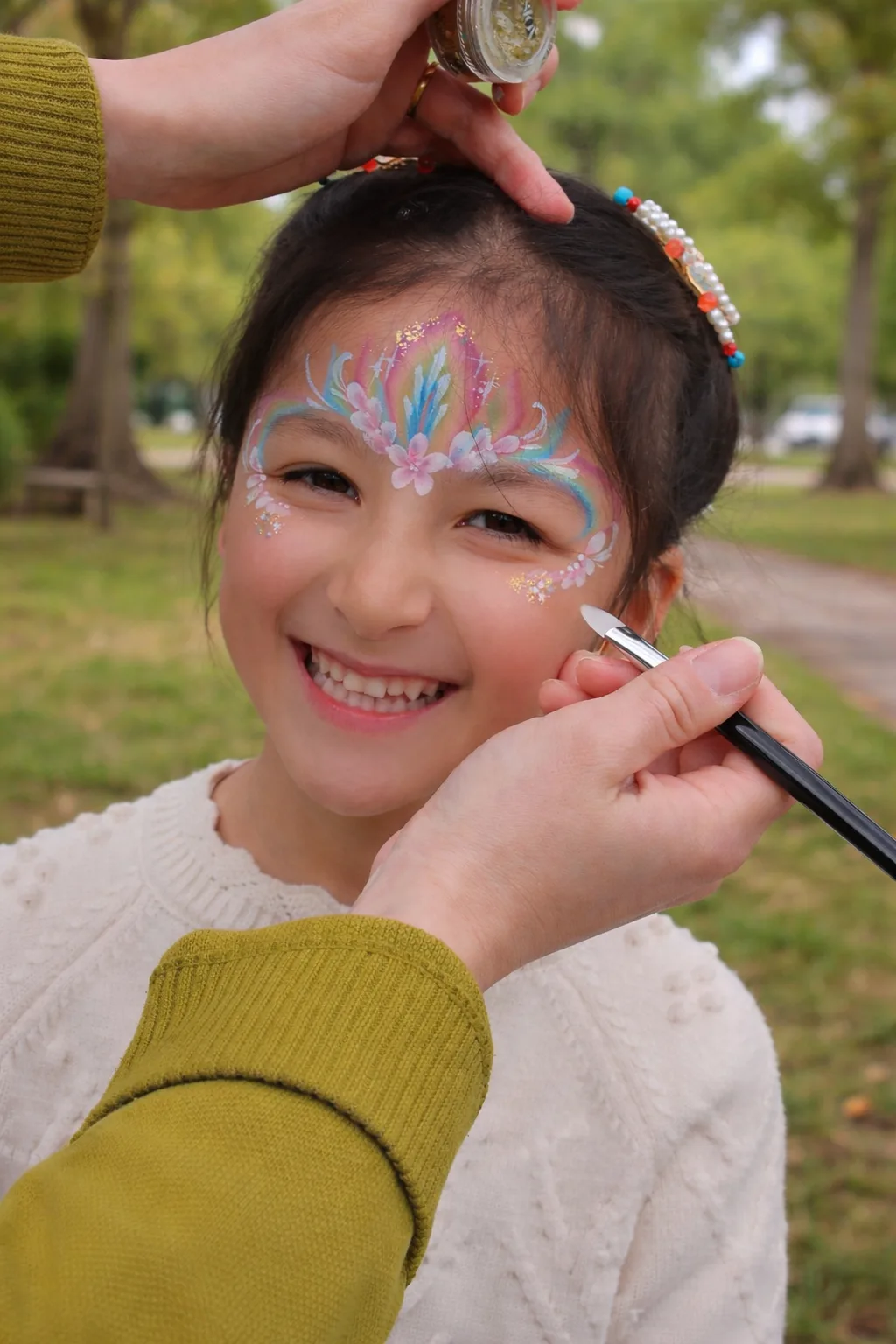 Smiling child with kawaii face painting in a park